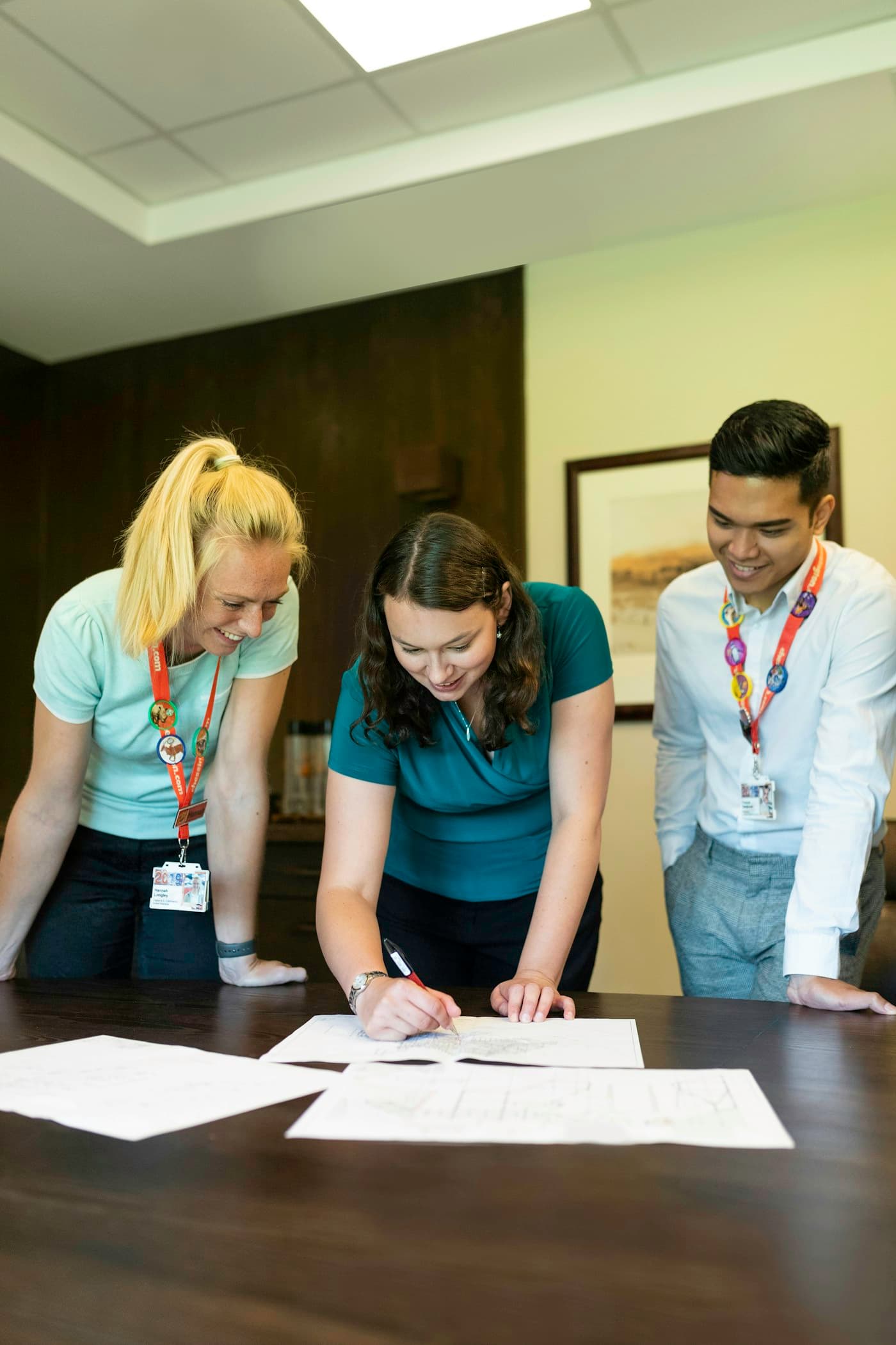 Three colleagues reviewing documents together.