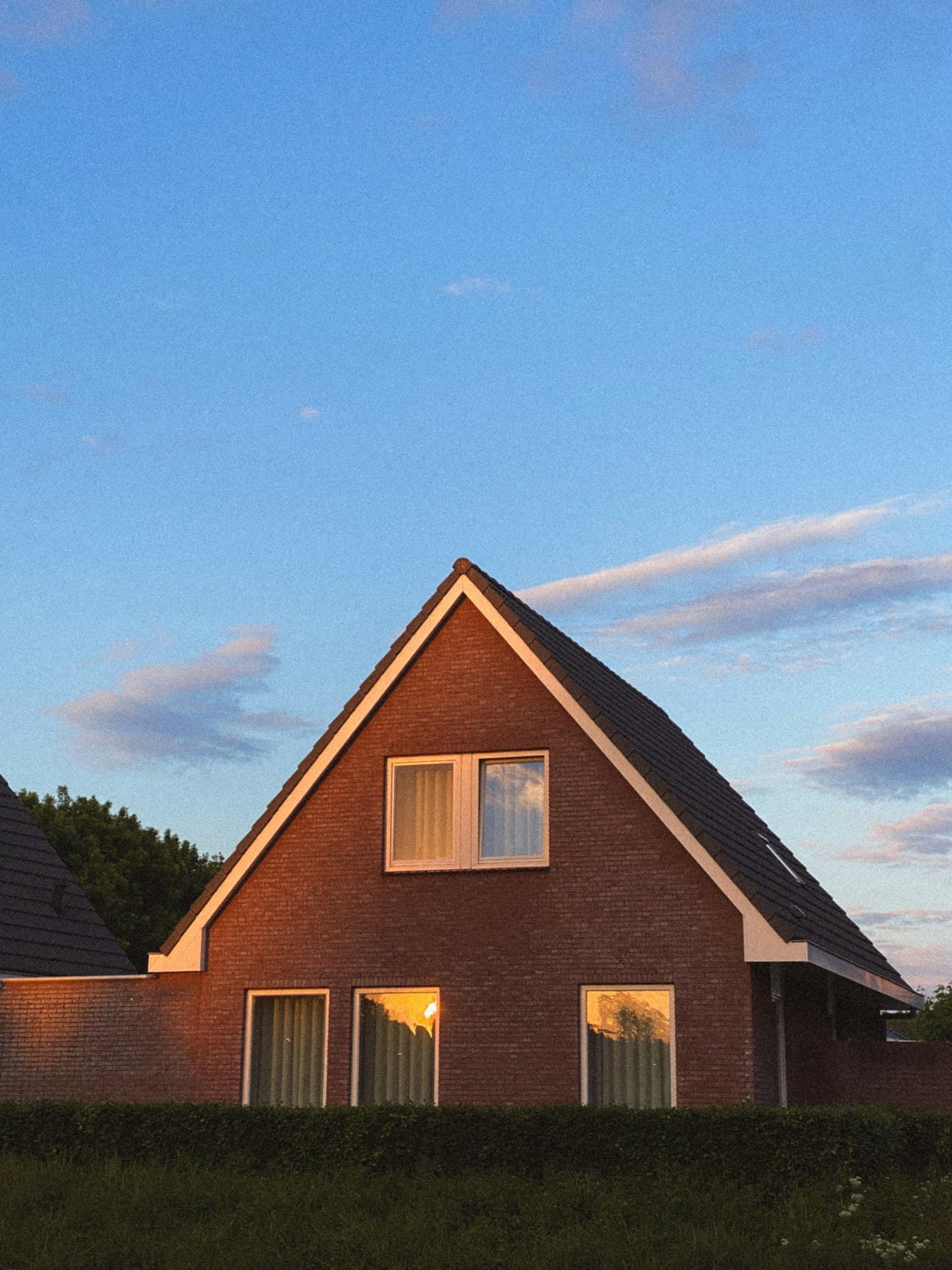 A brick house under a blue sky.