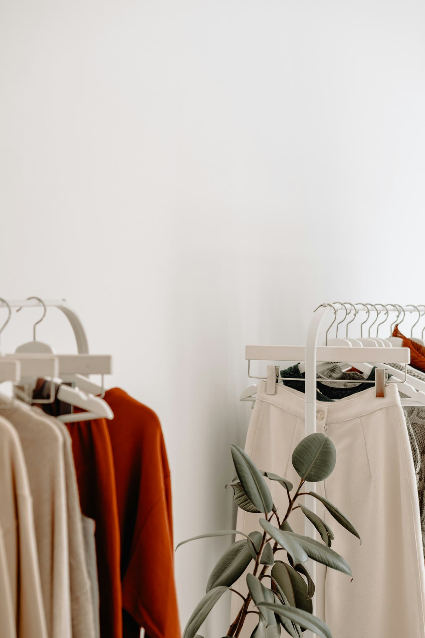 Clothes on a rail in a bright shop.